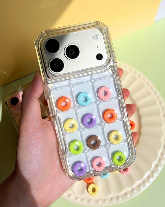 a clear bubble phone case decorated with rainbow loop charms