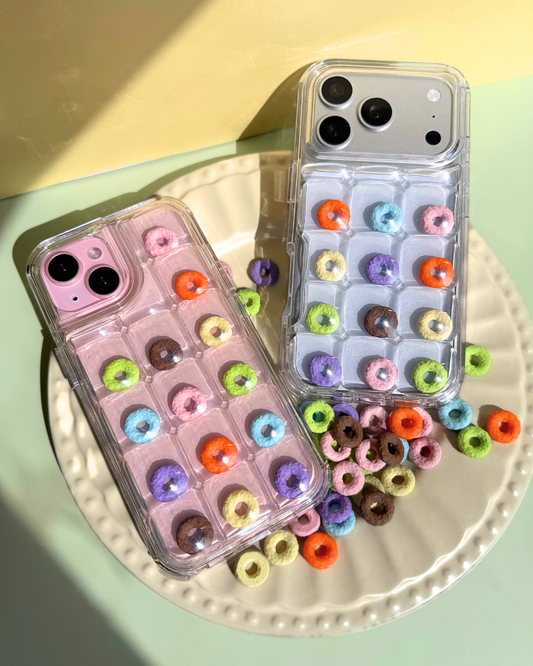 a clear bubble phone case decorated with rainbow loop charms
