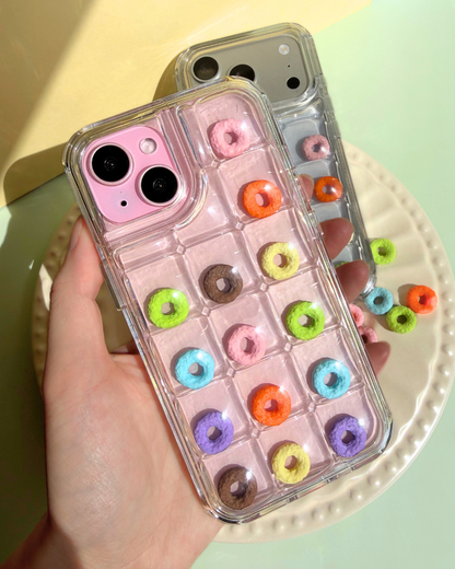 a clear bubble phone case decorated with rainbow loop charms