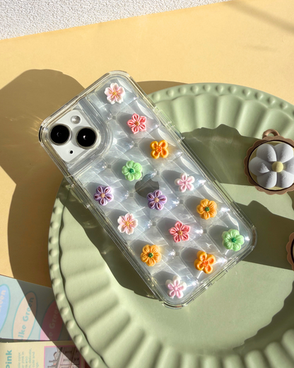 a clear bubble phone case decorated with cute flower charms