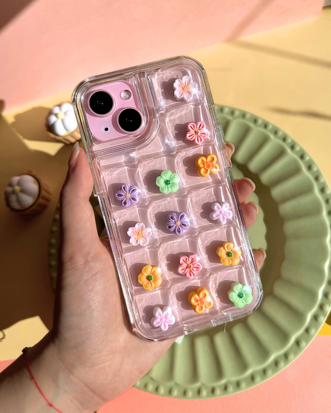 a clear bubble phone case decorated with cute flower charms