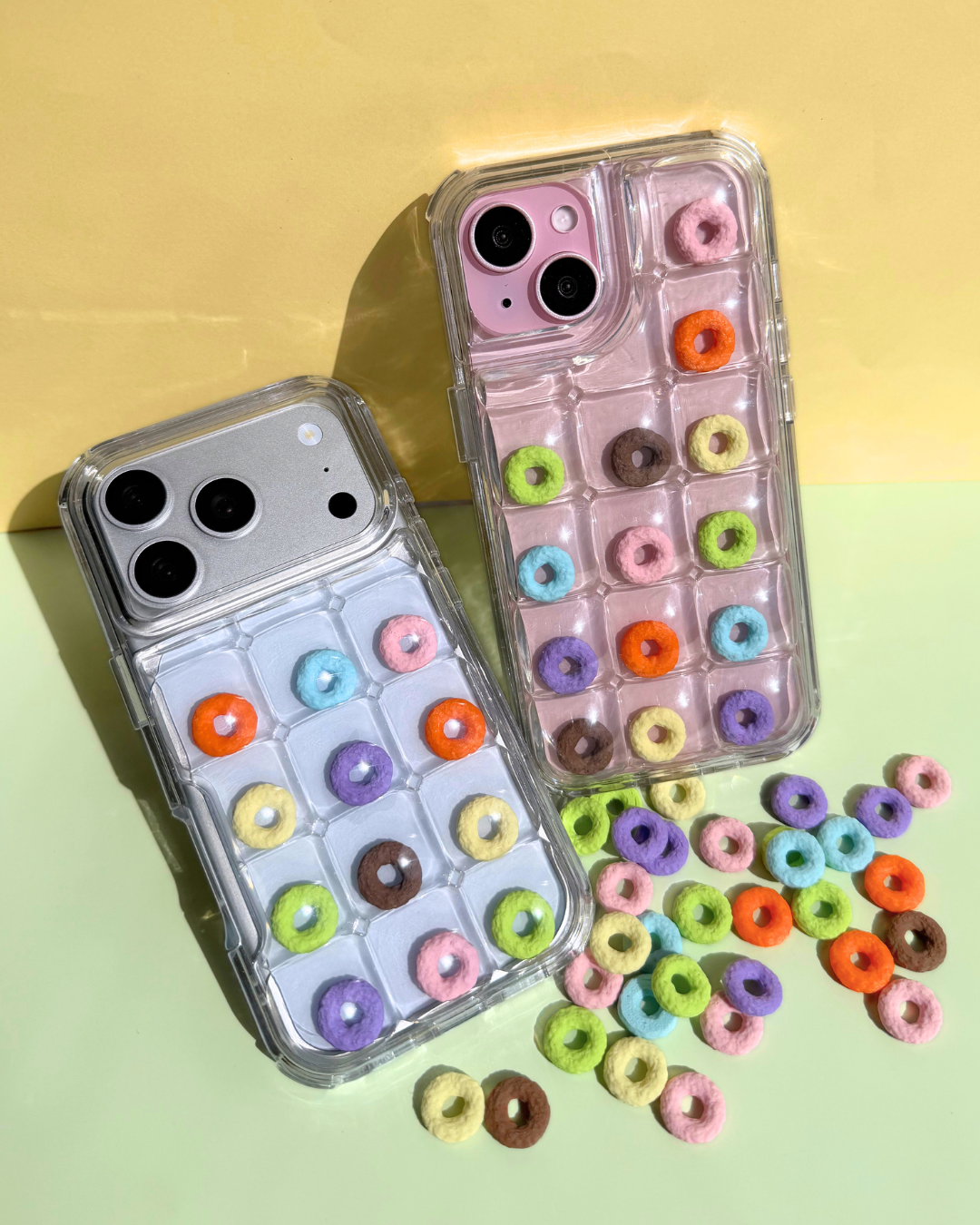 a clear bubble phone case decorated with rainbow loop charms