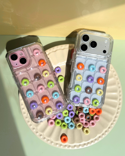 a clear bubble phone case decorated with rainbow loop charms
